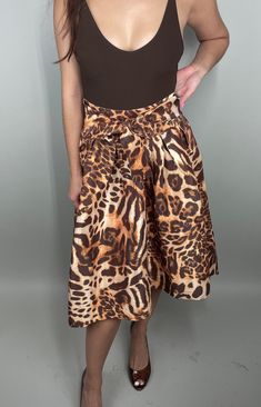 "💫  Details: *Bring some drama with this gorgeous animal print skirt in shades of gold and brown! *Features: High waist with side zipper closure, ties in the front, and fit & flare full silhouette with high/low hem. *Size in label: Small (fits more like XS, so I listed as such) *Model is size XS/0 and 5'3\" *66% polyester/ 30% nylon/ 4% spandex *Very good vintage condition! *Body suit sold separate  💫  Measurements (when laid flat): *Length: 24.5\" in the front and 34.5\" in the back- shorter in the front and longer in the back *Waist: 12\" (24\"-25\" waist) and has a little stretch *Hips: 22\" 💫  Please remember, vintage items tend to be pre-loved so may not be in perfect condition but still have lots of life left. I examine items for imperfections and will list and show pictures if an Stretch Hips, Animal Print Skirt, Shades Of Gold, Womens Skirts, Print Skirt, Body Suit, High Low Hem, Full Skirt, Printed Skirts