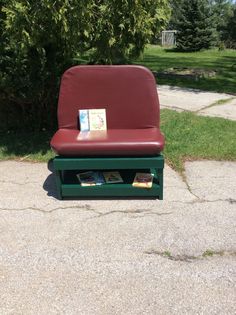 a red chair sitting on top of a green bench