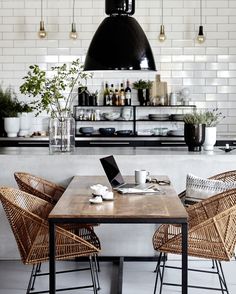 an instagram page with two chairs and a table in front of a kitchen island