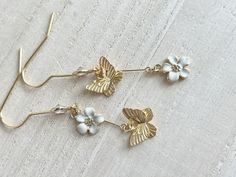 These dainty butterfly earrings with flowers are made of the followings: (1) Matt gold plated butterfly charm (Size: 8 x 10mm) (2) gold plated enamel flowers charm (size: 9 x 8mm) (3) gold plated earring hooks with cubic zirconia The total length of the earrings is about 47mm. ✏️ Please choose your desired color of flower 【BEFORE PURCHASE, PLEASE NOTE THE FOLLOWINGS】 ☆ VAT, GST and any other taxes from your country are NOT included in the listing price. Buyers are responsible for any aforesaid t White Butterfly Charm Earrings For Wedding, Whimsical White Butterfly Jewelry, White Dainty Butterfly Earrings, Dainty Butterfly Earrings For Wedding, Dainty White Butterfly Earrings, White Drop Earrings With Butterfly Charm, Ring Charm Necklace, Dainty Butterfly, January Birthstone Rings