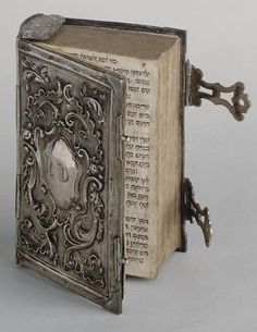 an old book with a key attached to it