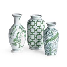 three green and white vases sitting next to each other