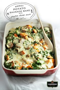 a casserole dish with meat, cheese and spinach in it on a white tablecloth