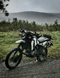 a black and white motorcycle parked on the side of a road