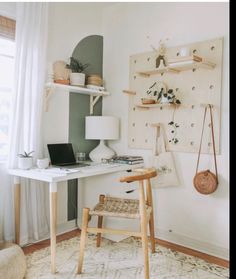 a white desk with a laptop on top of it next to a chair and lamp