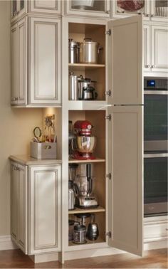 an open cabinet in the corner of a kitchen