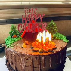 a chocolate cake with lit candles on top