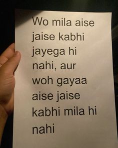 a person holding up a piece of paper with the words written in different languages on it