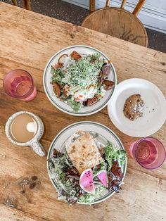 two plates with food and drinks on a wooden table