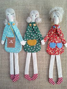 three handmade dolls sitting next to each other