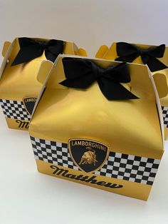 two yellow boxes with black bows on them