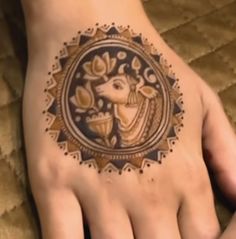 a woman's hand with a tattoo on it