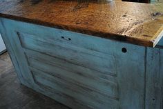 a kitchen island made out of an old wooden cabinet with drawers and knobs on it