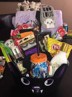 a basket filled with candy and snacks on top of a table