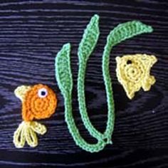 two crocheted goldfish and one orange fish