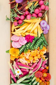 a wooden tray filled with lots of different types of vegetables