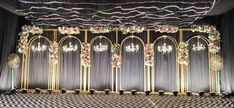 an elaborately decorated stage with chandeliers and flowers