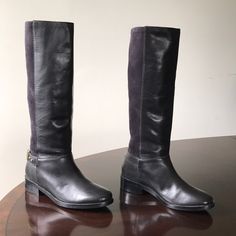 -Cole Haan Genuine Black Leather And Blue Sueded Leather. - Women’s Size 6.5b. - Pull On Riding Boots. - Leather Interior Lining And Rubberized Outsole. - 1.25” Block Heel. - Genuine And Authentic Or Your Money Back. - Height Measured Vertically From Tip Of Top Of Boots To Bottom Tip Of Block Heel To Give An Estimate Of Height Length = 41cm. Elegant Leather Moto Boots With Wide Calf, Elegant Wide Calf Leather Moto Boots, Formal Boots With Leather Trim And Round Toe, Leather Trim Round Toe Work Boots, Leather Trim Round Toe Boots For Work, Medium Width Leather Riding Boots, Boots Leather, Cole Haan Shoes, Blue Suede