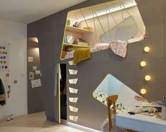 a child's bedroom with a loft bed, desk and shelves on the wall