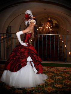 a woman in a red and white dress is posing for the camera