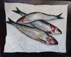 two fish are sitting on a piece of paper in front of a black framed painting