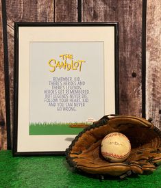 a baseball in a mitt next to a framed poster with the quote'the sandlot '