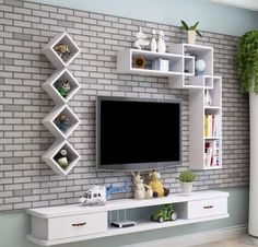 there is a television on the wall in this living room with white shelves and shelving