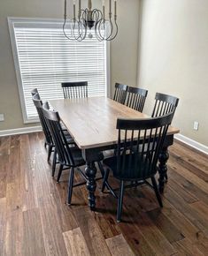 a dining room table with six chairs and a chandelier