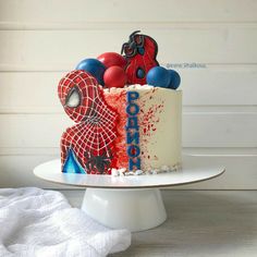 a spiderman themed cake on a white plate