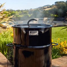 a large black pot sitting on top of a grill