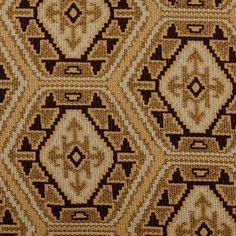 an old rug with brown and white designs on it's sides, in the shape of hexagons