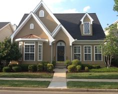 a house that is brown with white trim and windows