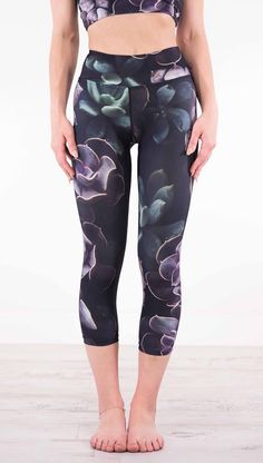 a woman in black and purple floral print leggings