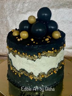 a black and white cake with gold decorations