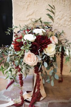 a bridal bouquet with red and white flowers