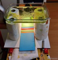 a glass container filled with liquid sitting on top of a table