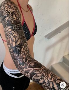 a woman with tattoos on her arms and arm