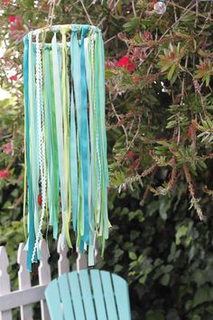 a wind chime hanging from the side of a tree