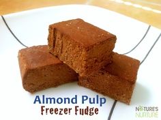 three brownies stacked on top of each other on a plate with the words almond pulp freezer fudge