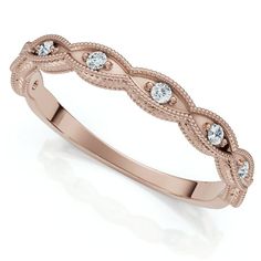 a rose gold wedding ring with diamonds on the sides and an intricate design in the middle