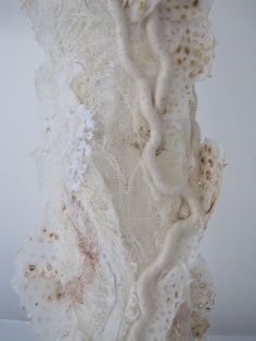 a piece of art that looks like it is made out of fabric and laces