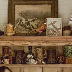 a shelf filled with lots of different types of coffee mugs and other decorative items