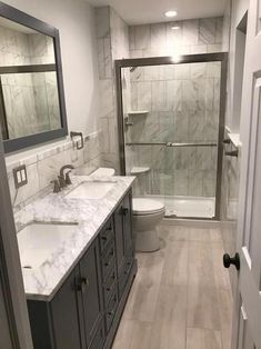 a bathroom with marble counter tops and double sinks