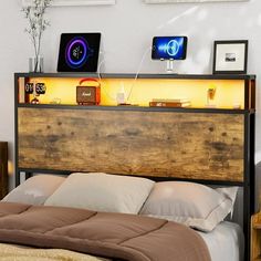 a bed with a wooden headboard and night stands on top of it in a bedroom