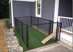 a black chain link fence in front of a house