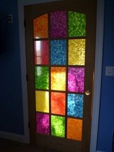 the door is decorated with multicolored glass blocks and has a light shining through it