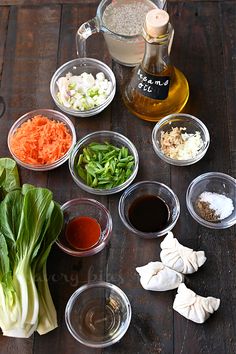 an assortment of vegetables and seasonings on a wooden table