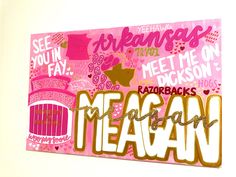 a pink and gold sign that says mean on it's side with words written in large letters