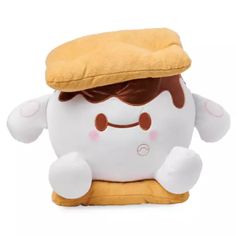 a stuffed toy with a hat on it's head and eyes, sitting in front of a white background