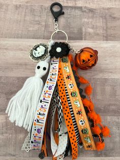 an assortment of halloween ribbons hanging from a hook